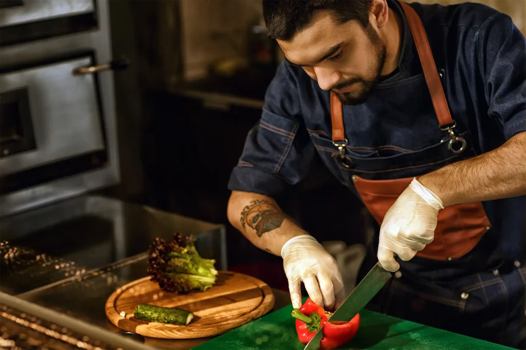 Chef cutting paprika